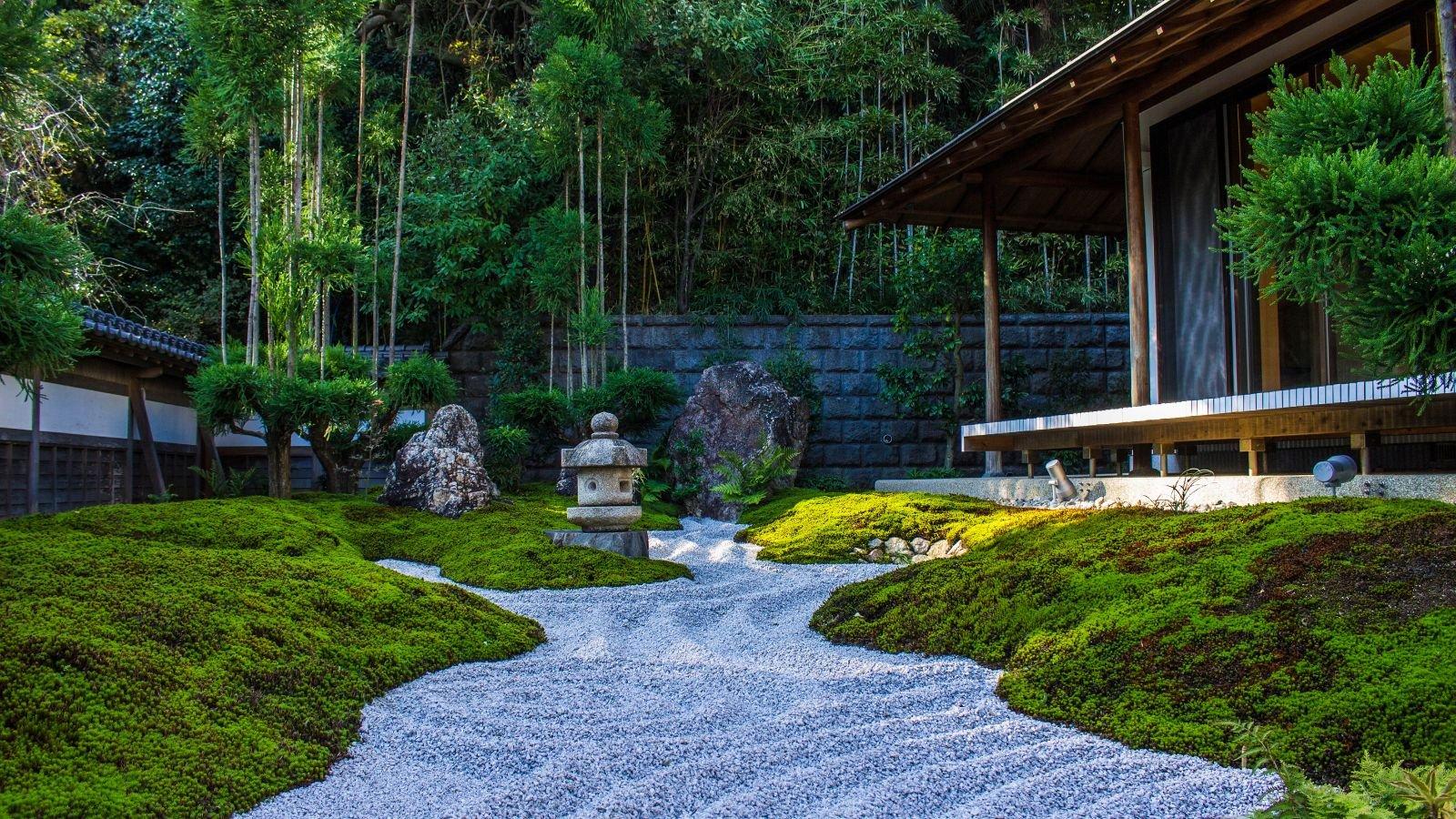 A peaceful Japanese zen garden with raked sand and green tea