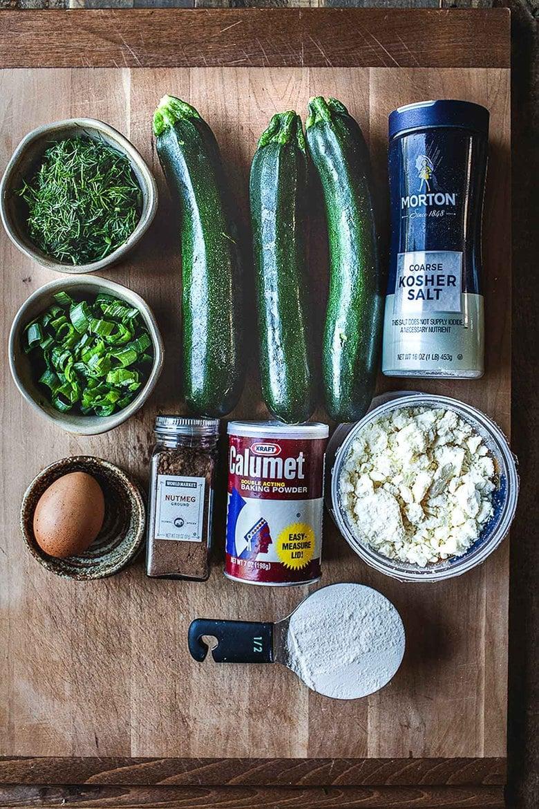ingredients for Zucchini and Feta Bake laid out on a wooden table