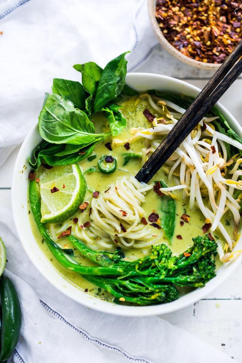 Thai green curry with noodles and vegetables in a bowl