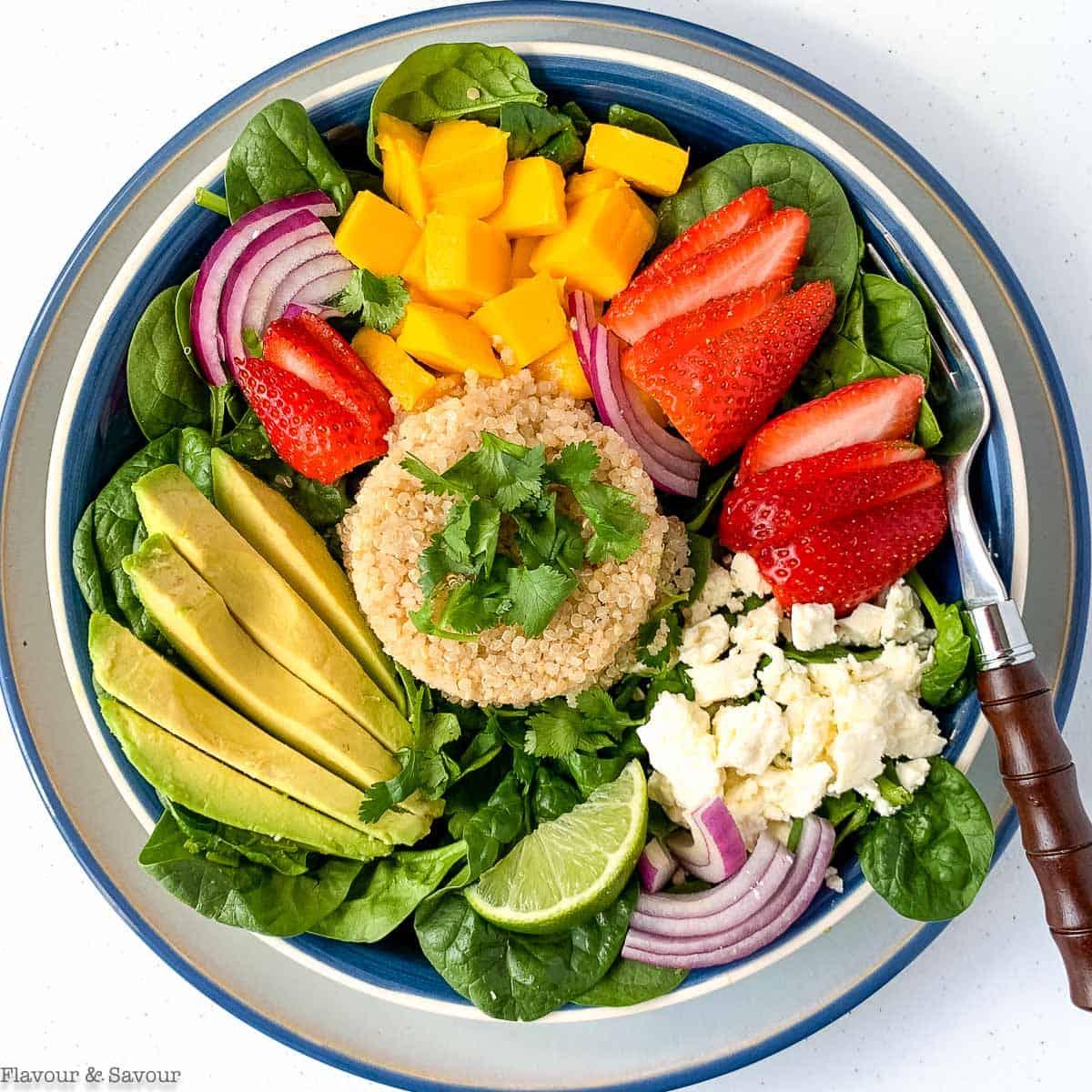 Overhead shot of a vibrant Strawberry Spinach & Quinoa Power Salad in a large bowl