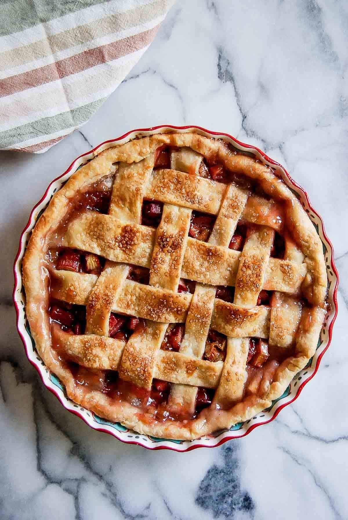 Ingredients for a blackberry rhubarb pie on a wooden countertop