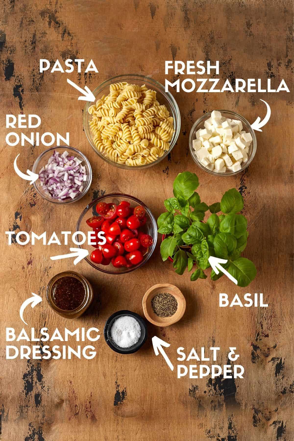 ingredients for Caprese salad with cappelletti: fresh mozzarella, ripe tomatoes, basil, and cappelletti pasta