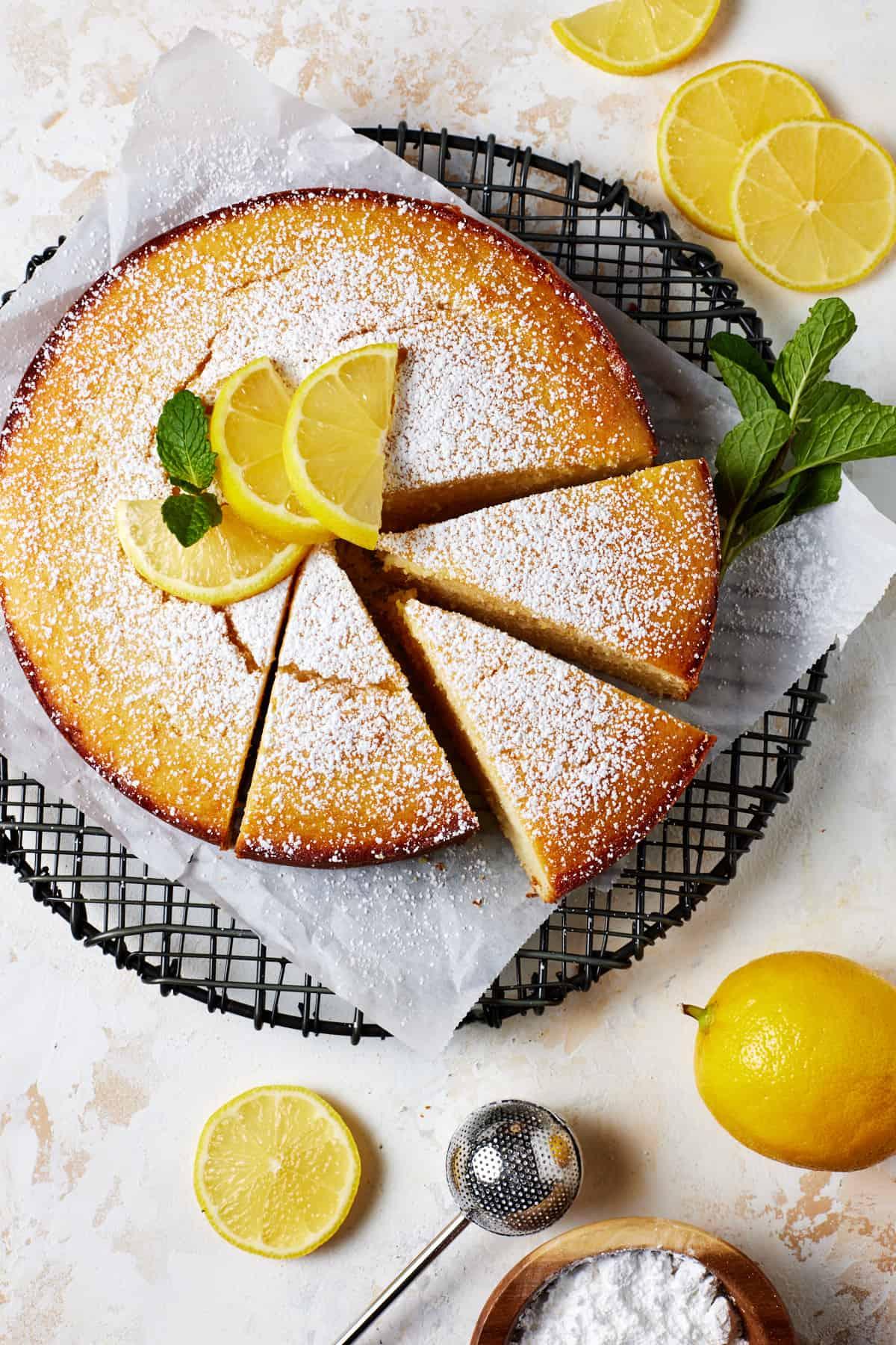 a vibrant lemon ricotta cake with a dusting of powdered sugar, served on a rustic wooden board