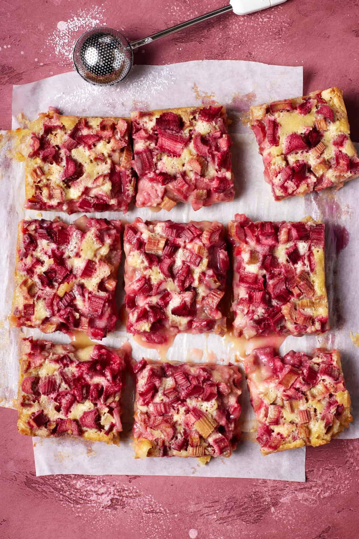 rhubarb polenta bars being cut into squares