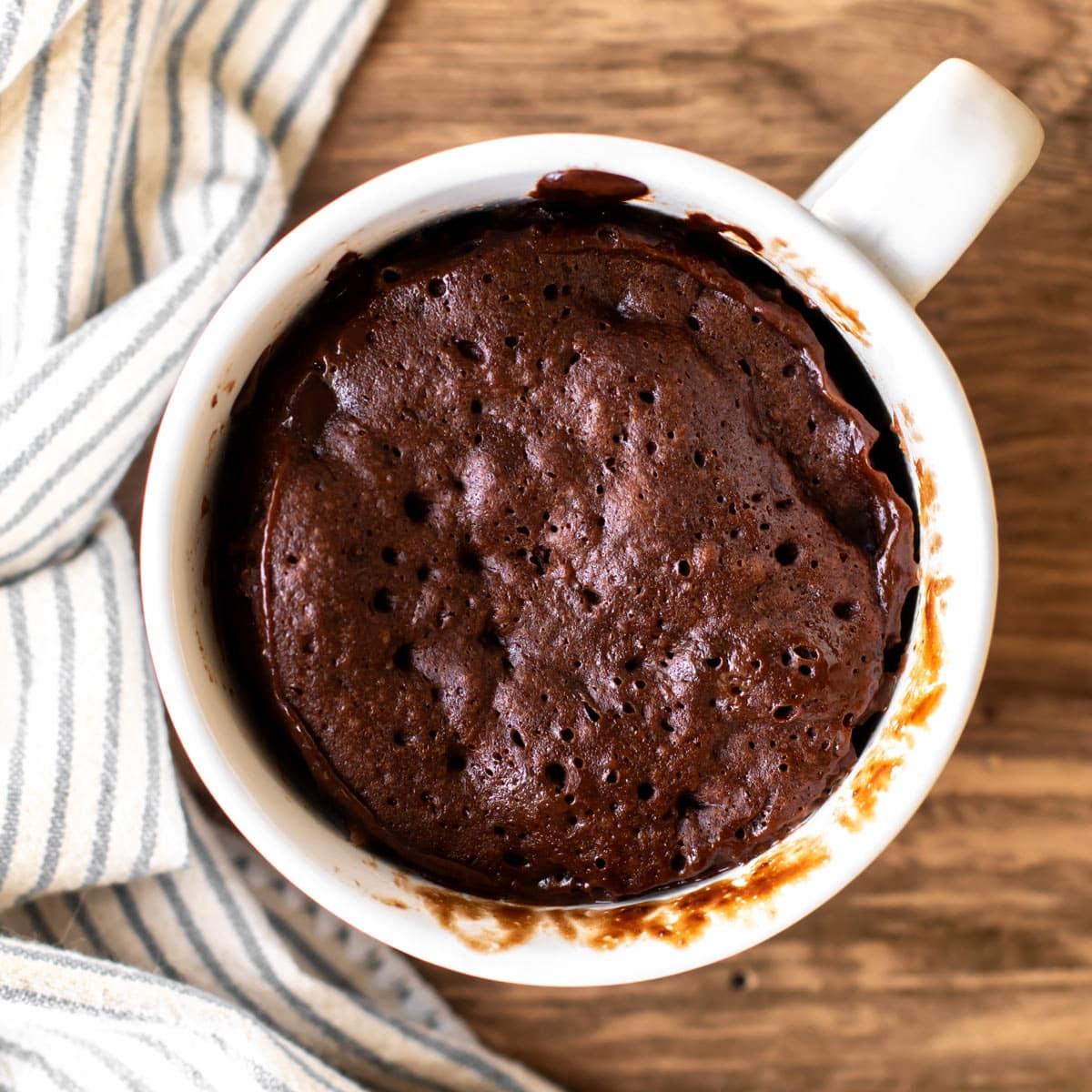 a person enjoying a dark chocolate cayenne pepper mug cake with a spoon