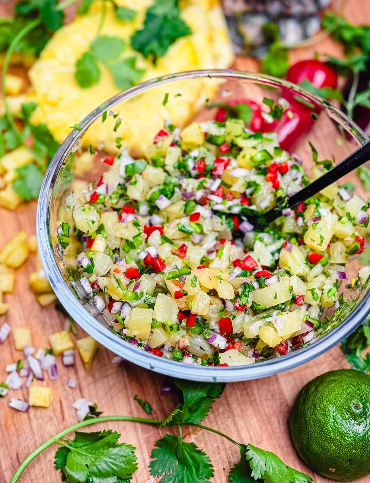 Freshly made pineapple salsa in a glass bowl