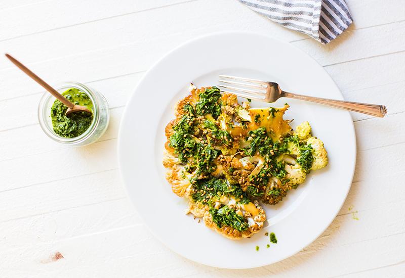 teriyaki glazed cauliflower steaks on a plate with sesame seeds