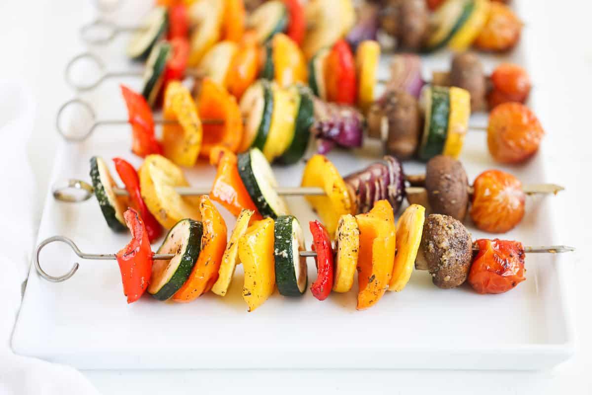 close up of grilled vegetable skewers on a platter