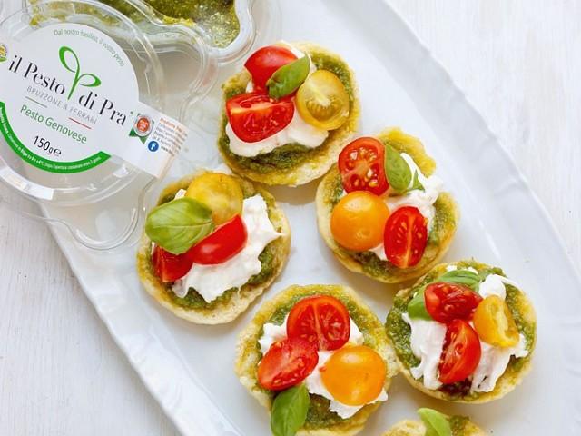 basil pesto mini cakes served on a platter with fresh basil leaves