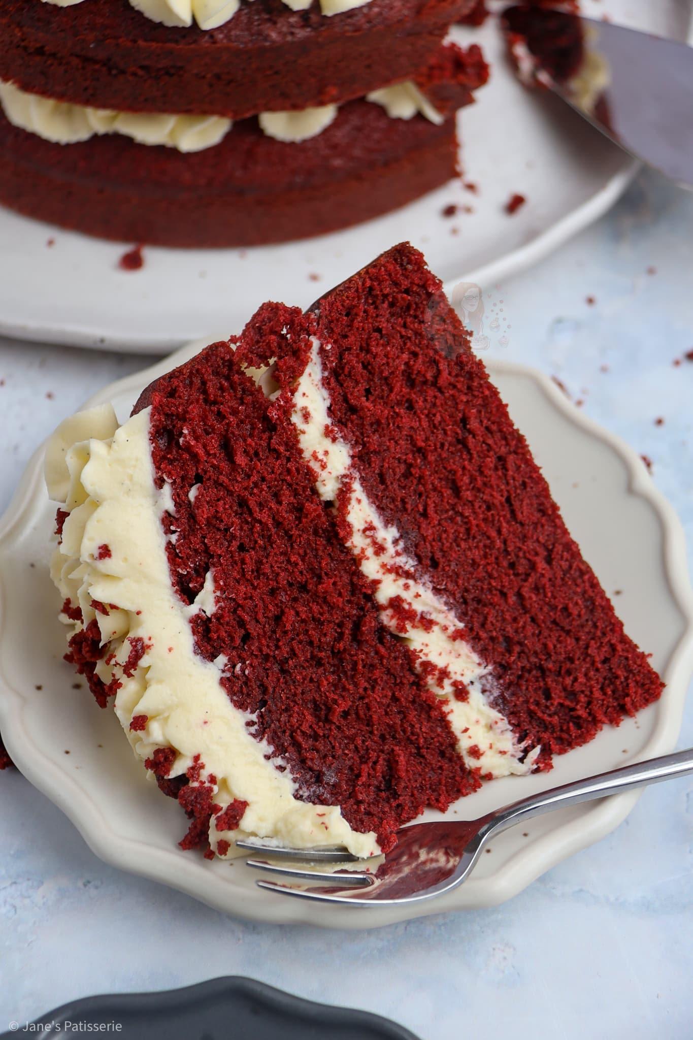 slice of ruby red velvet cake showing layers