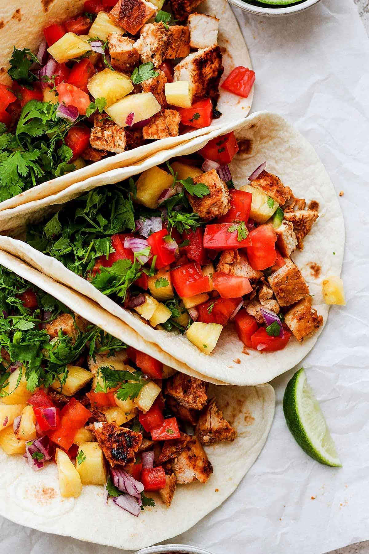 summer salsa chicken served in tacos with various toppings