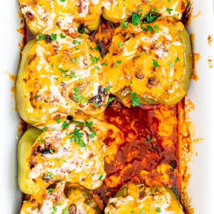 overhead shot of a baking dish filled with Tex-Mex chicken and rice stuffed peppers