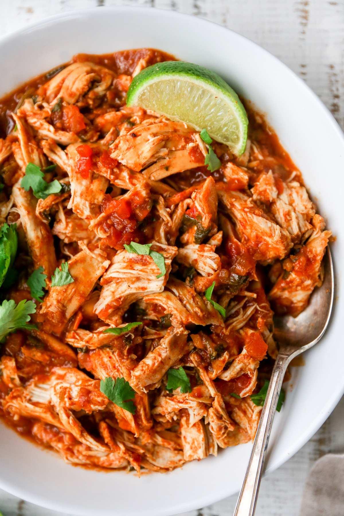 chicken breasts covered in salsa in a slow cooker