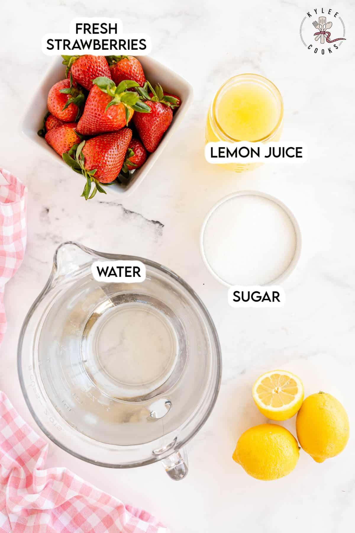 Ingredients for strawberry lemonade air freshener laid out on a wooden table
