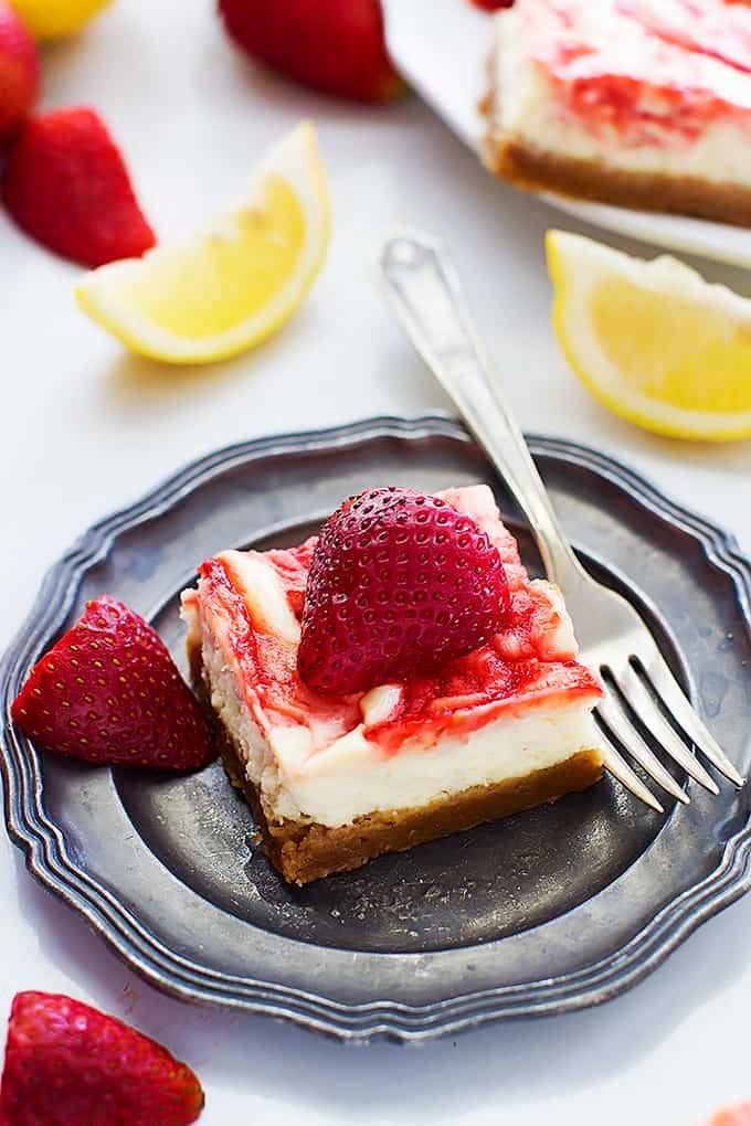 slice of strawberry lemonade cheesecake on a plate