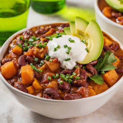 Ingredients for sweet potato and corn vegan chili arranged on a wooden surface