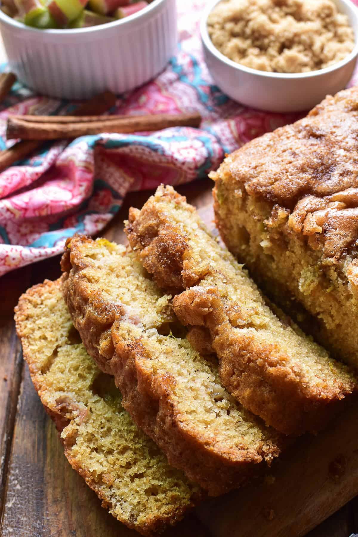 slices of cardamom rhubarb bread on a wooden board