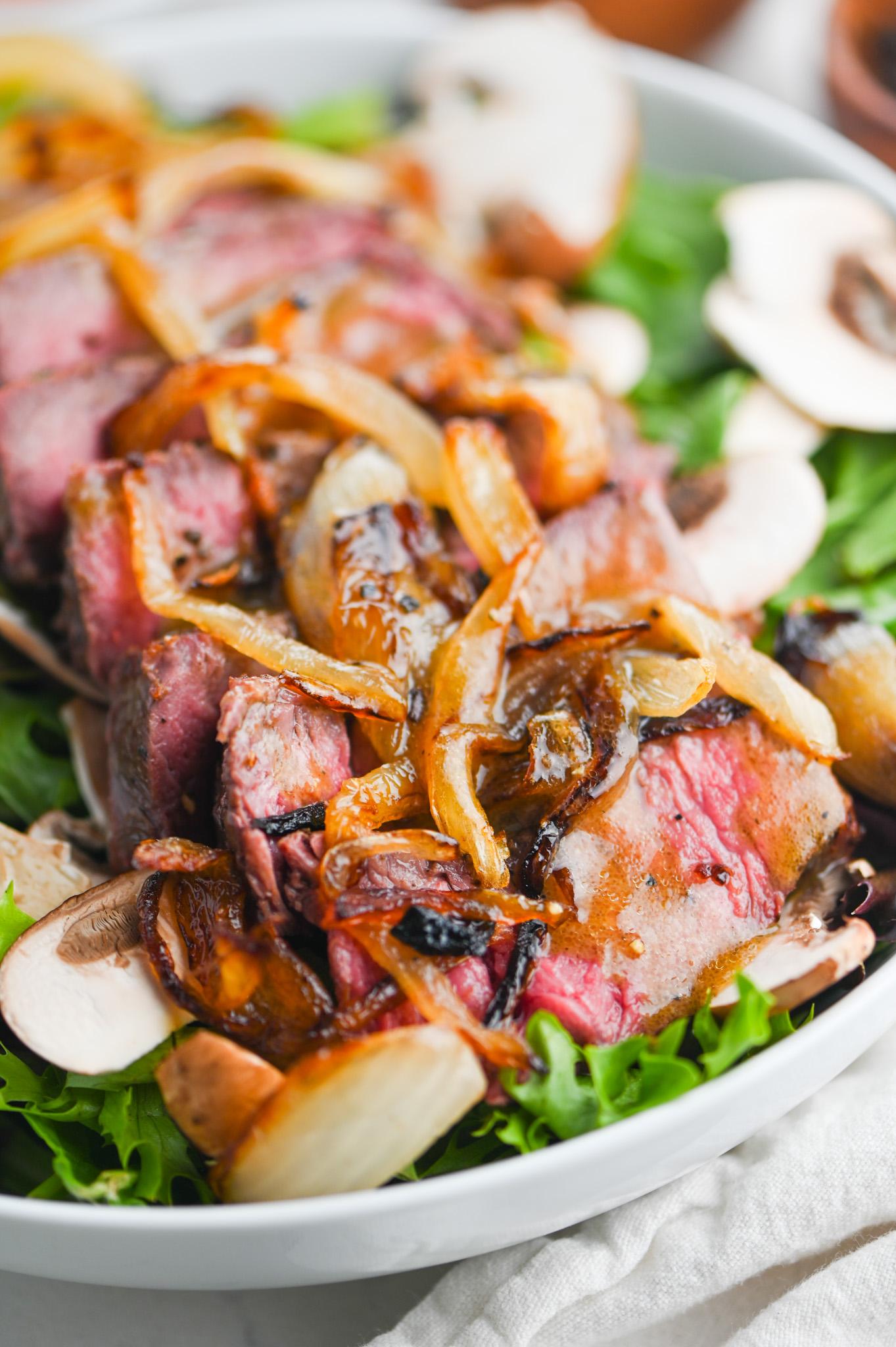 steak salad with dijon mustard vinaigrette on a festive holiday table
