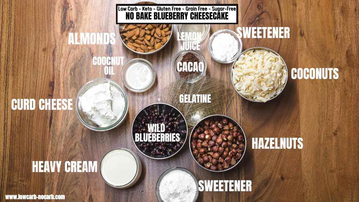 Overhead shot of the ingredients for low carb blueberry cheesecake bites laid out on a wooden surface.