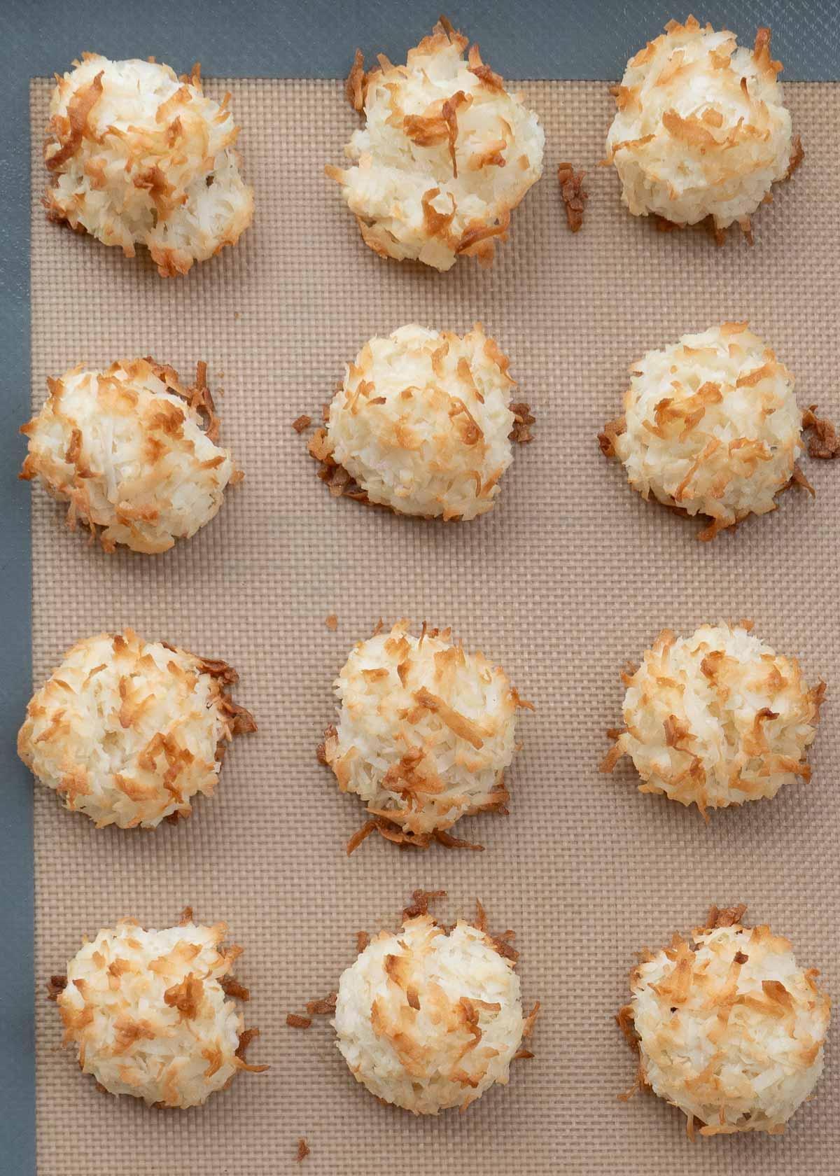 overhead shot of coconut almond macaroons on a baking sheet