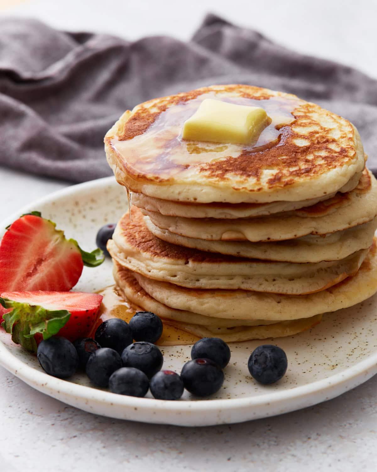 Close-up shot of golden-brown gluten-free pancakes stacked on a plate