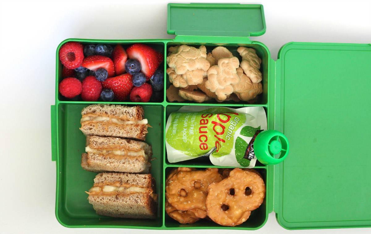 overhead shot of a person packing a peanut butter banana bento box
