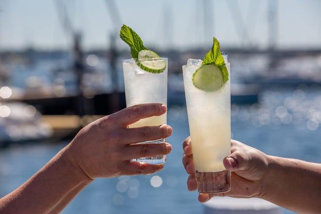 people enjoying cucumber sage lemonade on a sunny patio