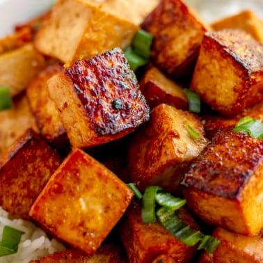 a close-up of perfectly cooked tofu cubes