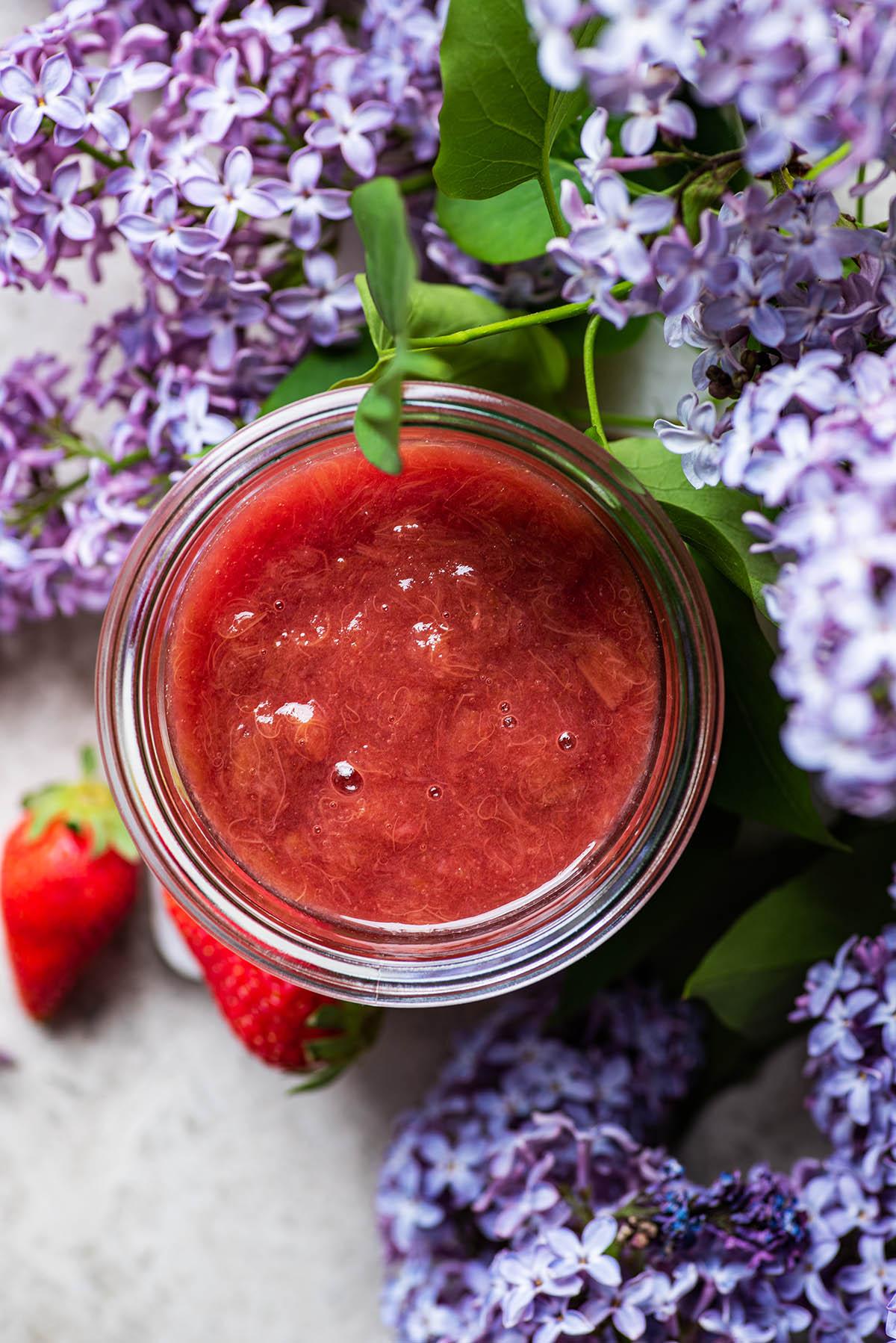 close up shot of Citrus Burst Rhubarb Compote in a glass jar, showcasing the vibrant colors and textures