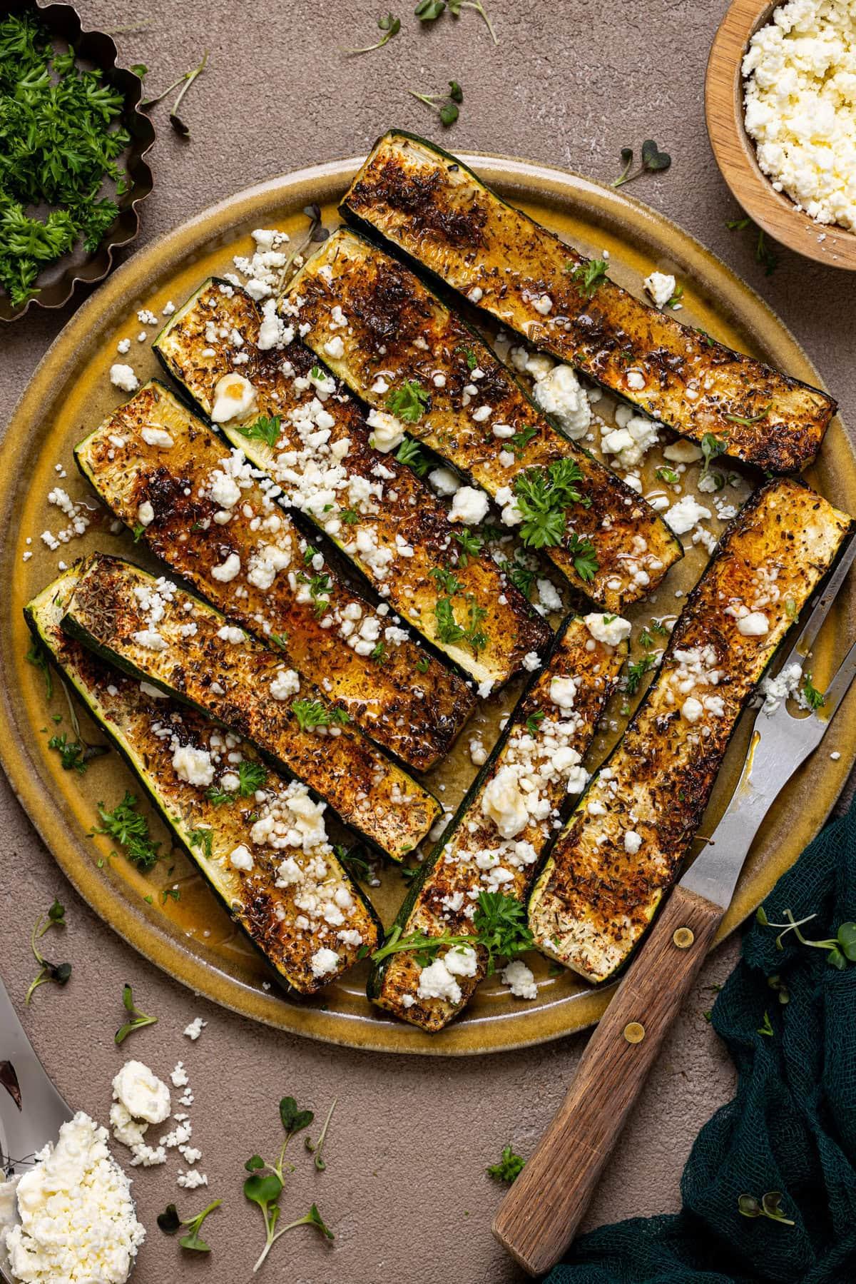 Overhead shot of the Honey Sriracha Zucchini Bake in a baking dish, garnished with parsley