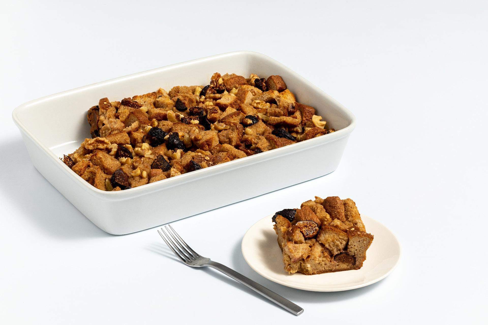Close-up shot of port fig walnut bread pudding with visible figs and walnuts