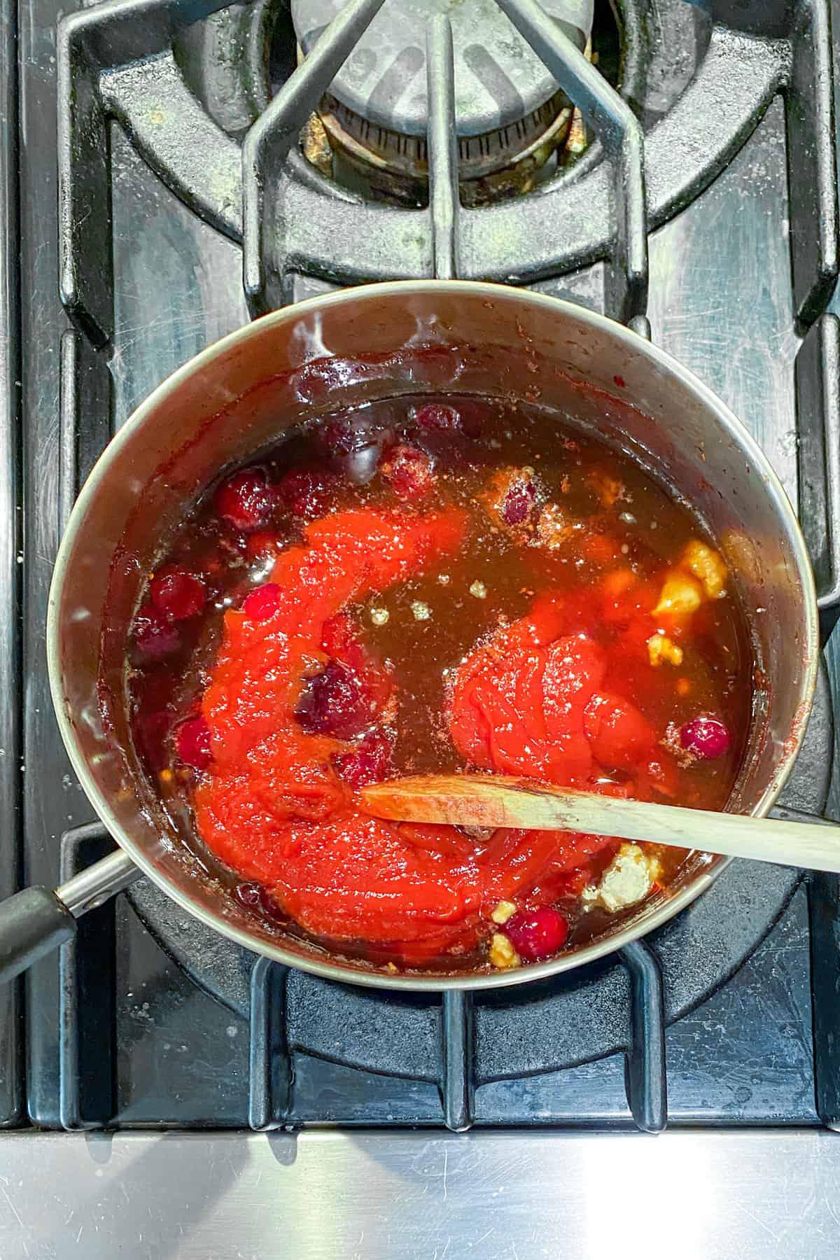 a pot of simmering cranberry orange BBQ sauce