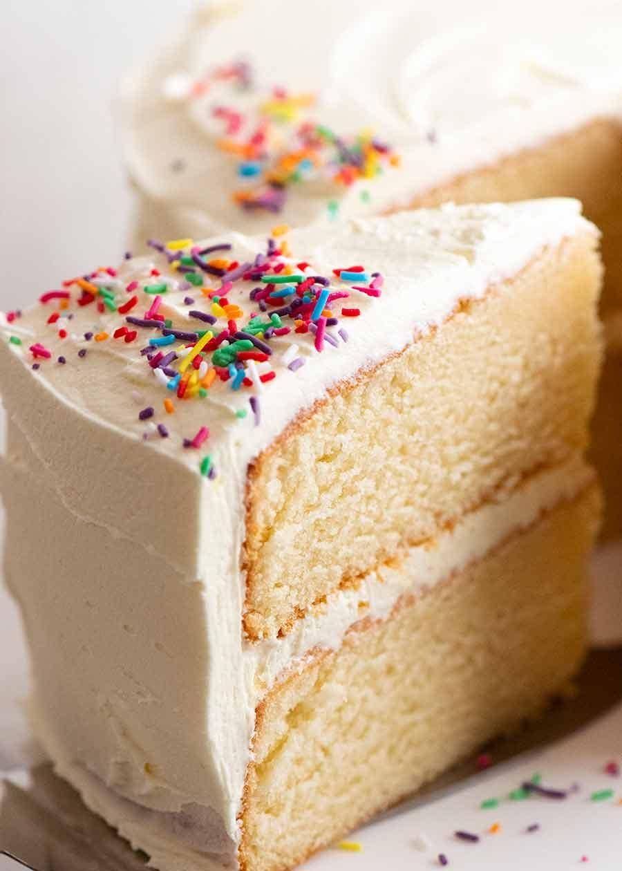 close up of a slice of cake with buttercream frosting