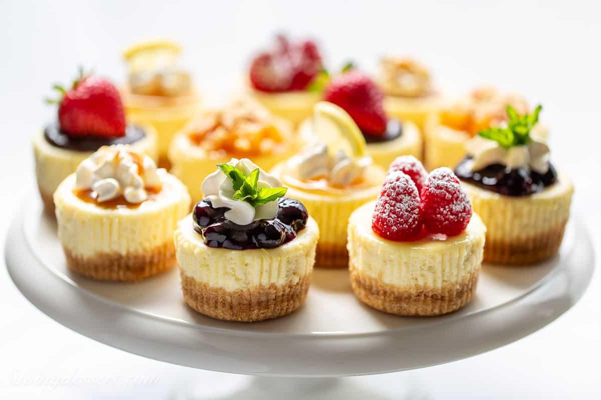 assortment of mini cheesecakes with various toppings
