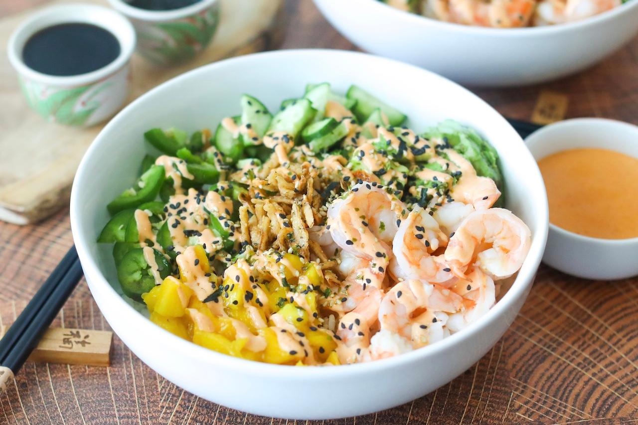 overhead shot of multiple rainbow dragon roll deconstructed bowls on a table