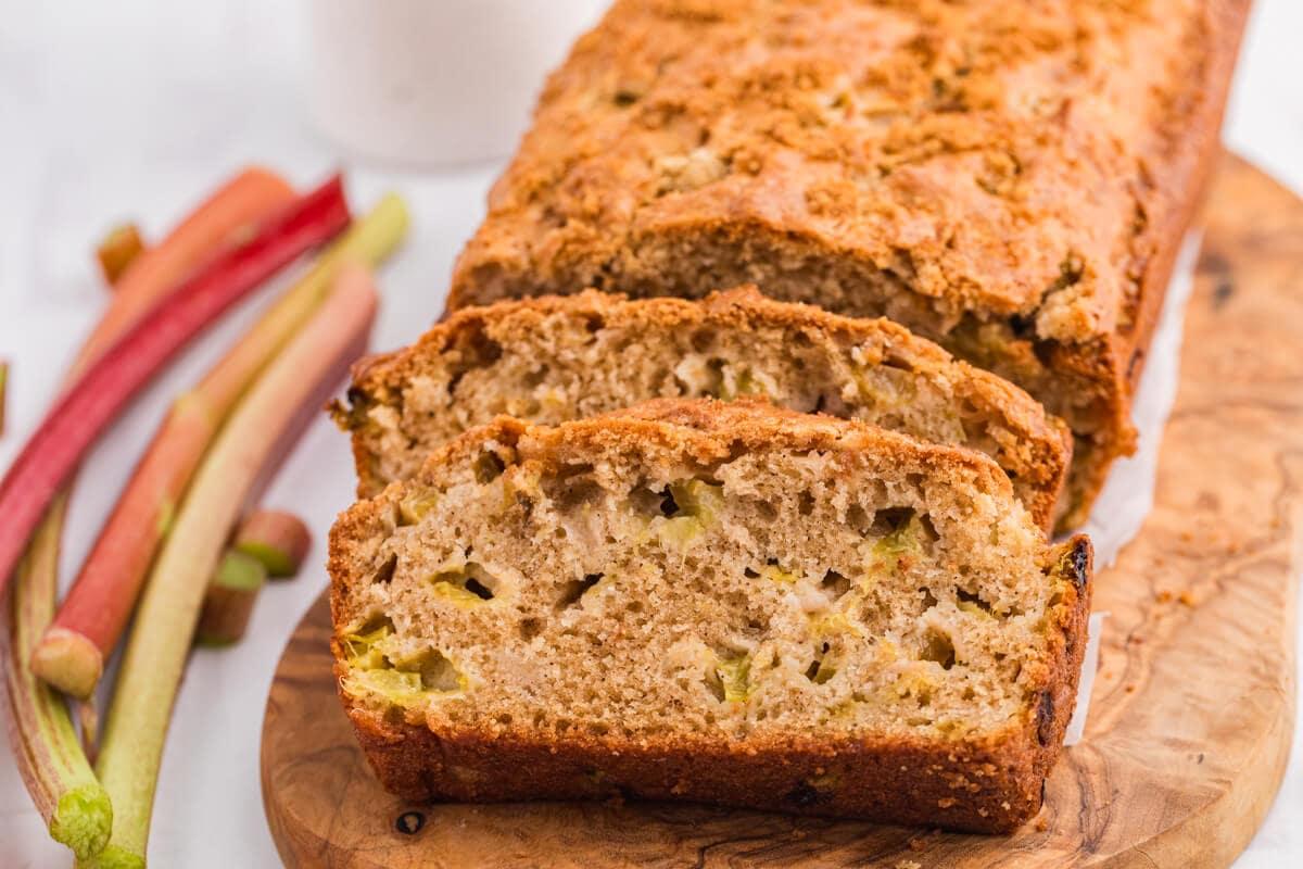 slices of homemade rhubarb rice bread on a wooden cutting board