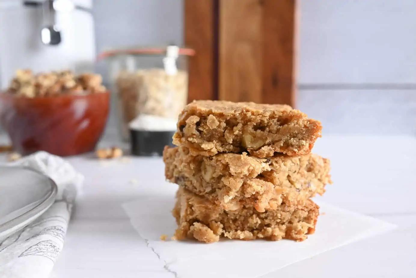 close up shot of maple walnut blondies with a piece being lifted out