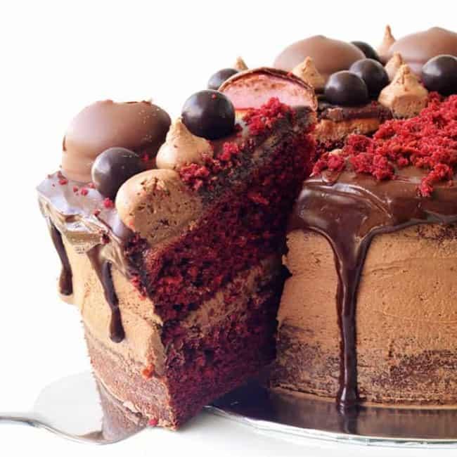 red velvet prism cake being frosted with chocolate ganache