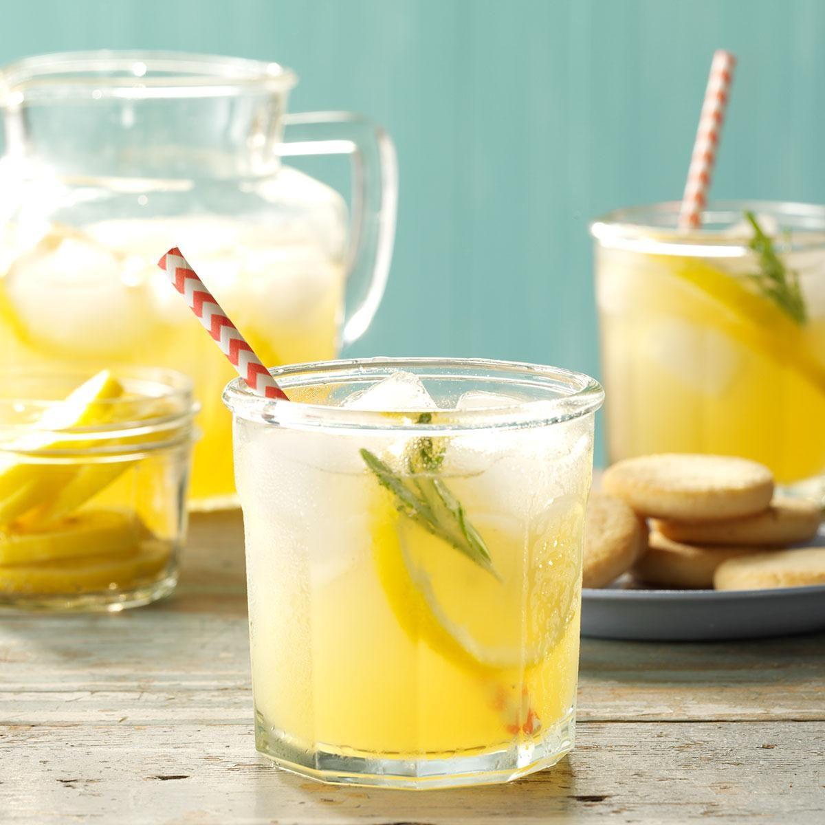 pitcher of rosemary lemonade with lemon slices and rosemary sprigs