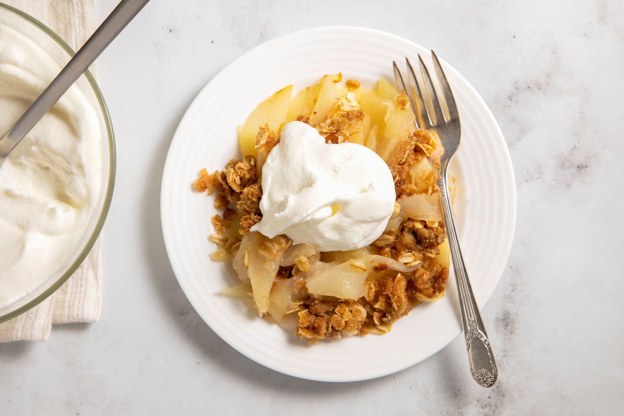 overhead shot of pumpkin spice pear crisp with a scoop of vanilla ice cream