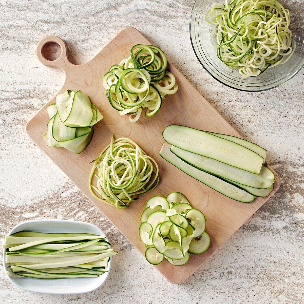 fresh zucchini being spiralized into noodles