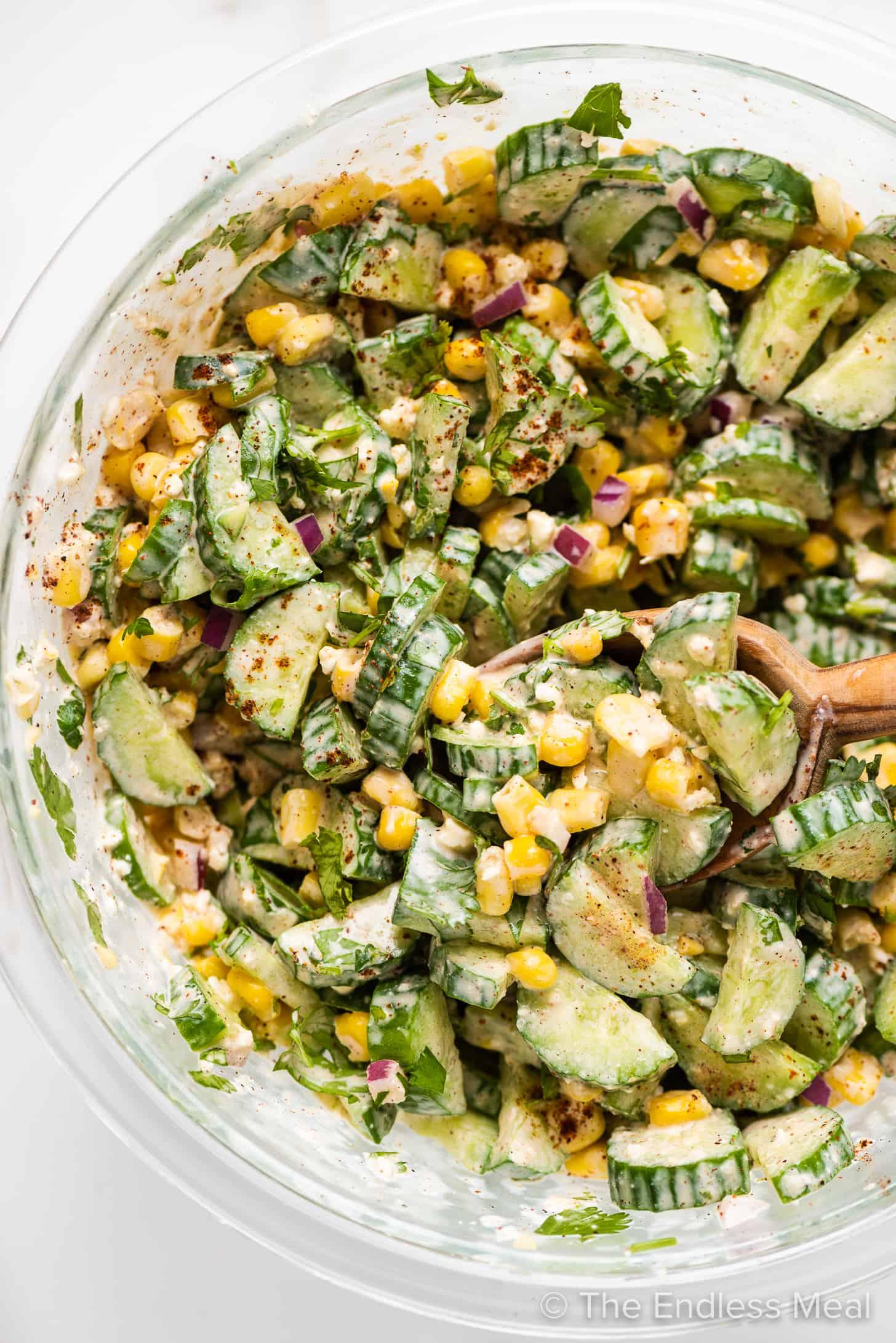 Elote cucumber salad in a bright, colorful bowl
