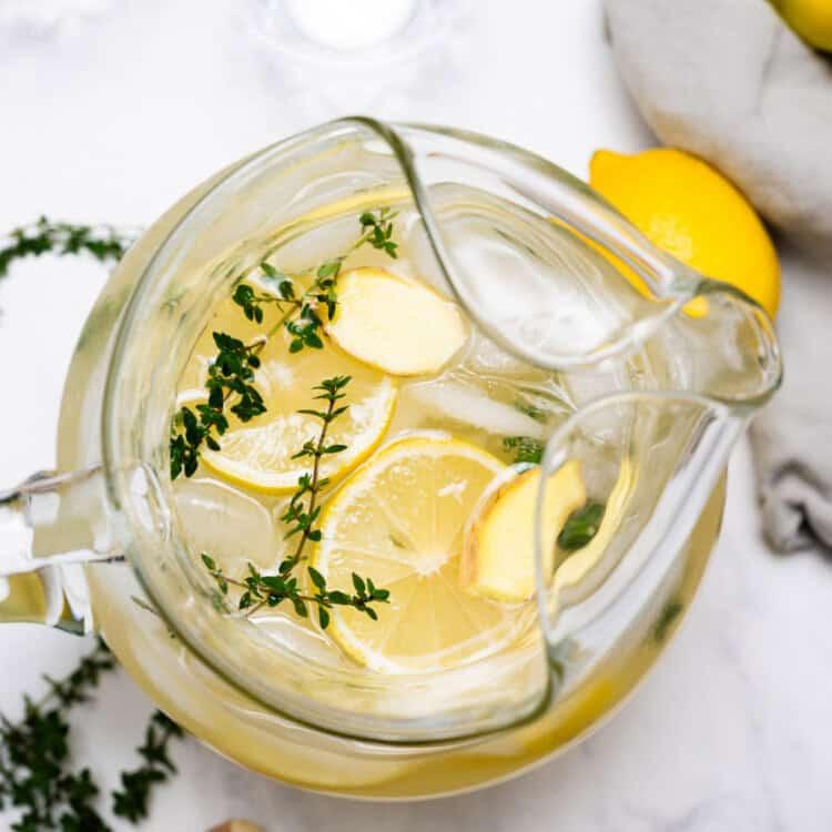 Pitcher of Ligurian Lemonade with Thyme on a table setting