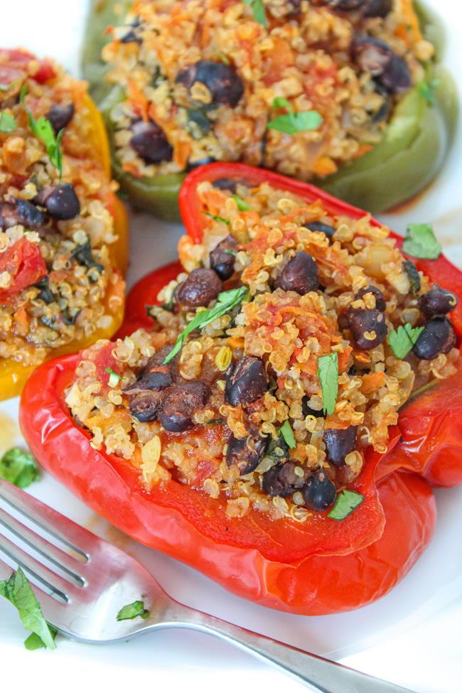 colorful stuffed bell peppers with black beans, avocado, and corn filling