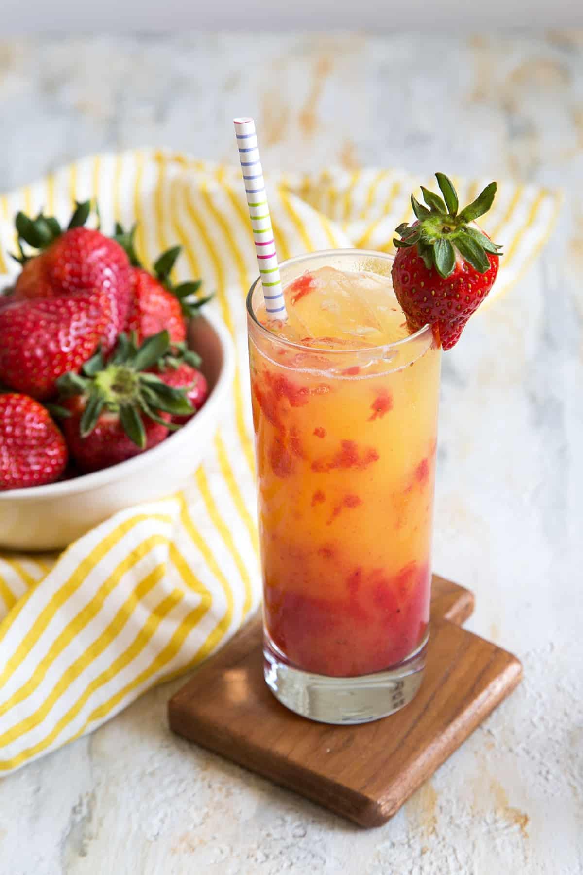 Close-up shot of a Strawberry Lemonade Tequila Sunrise cocktail with visible layers