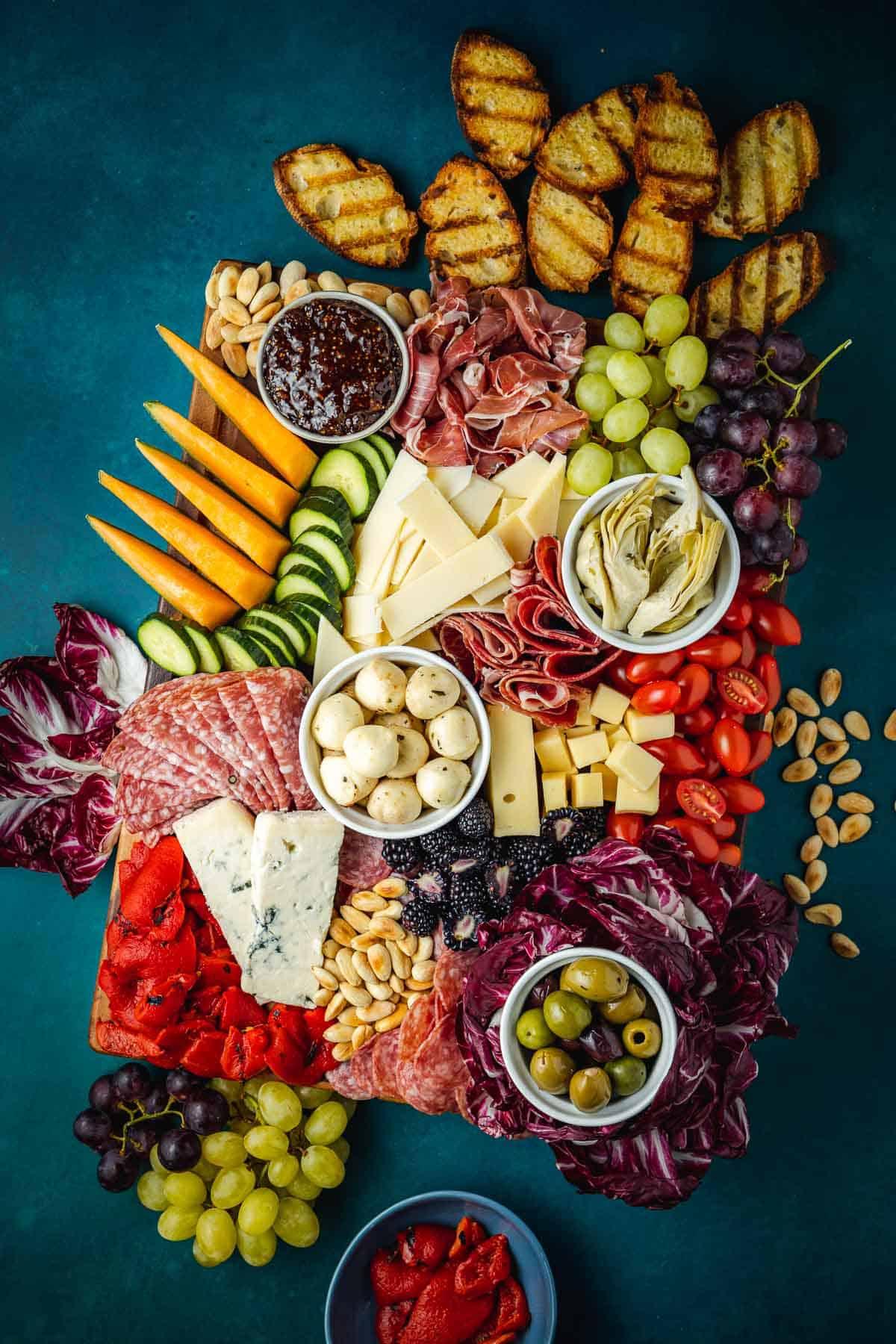 overhead shot of a cheese platter being shared at a gathering