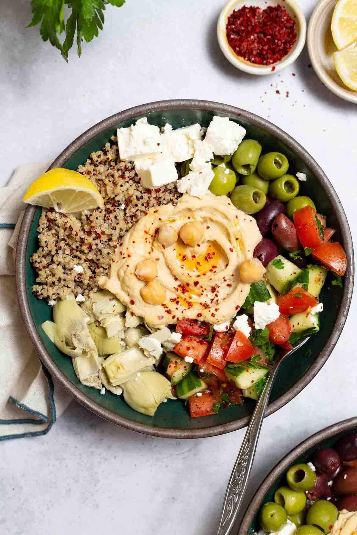 overhead shot of a vibrant Mediterranean Quinoa Bowl with various colorful ingredients