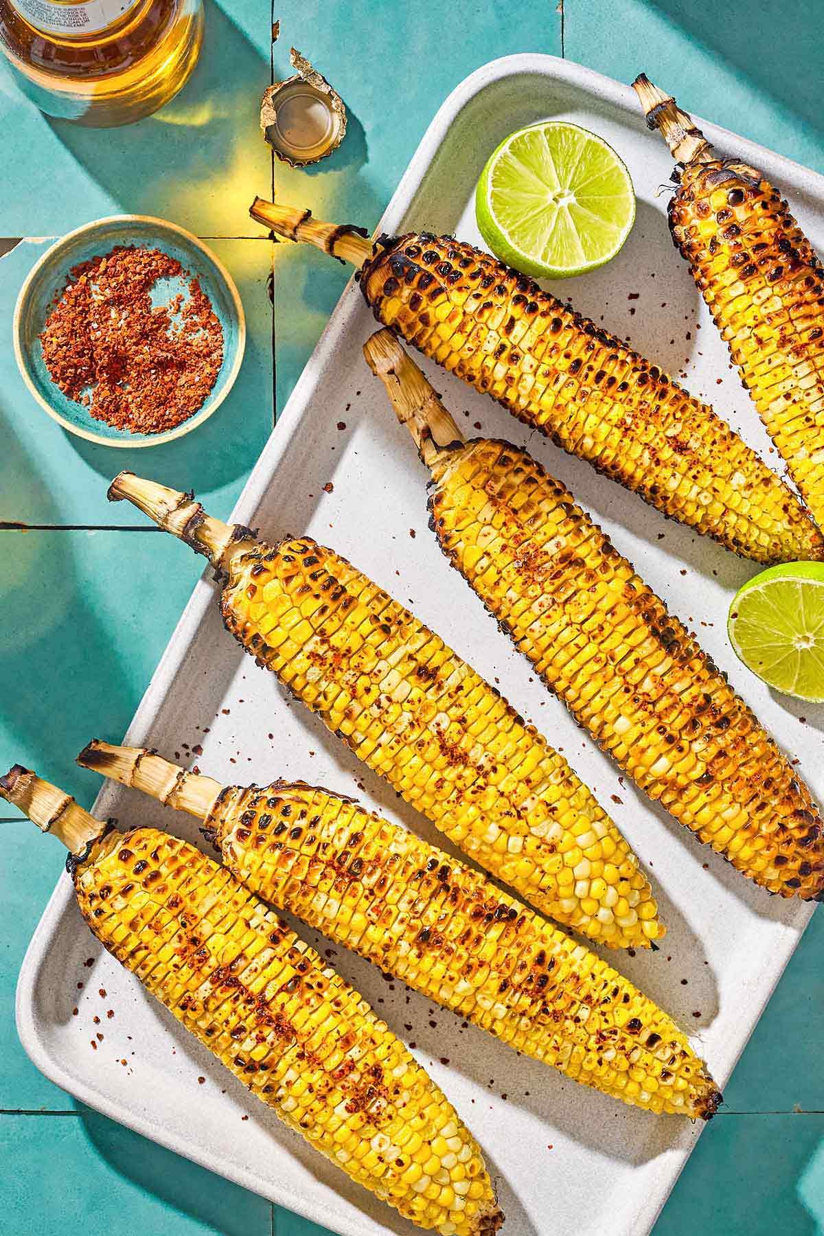 overhead shot of several ears of garlic parmesan grilled corn on a platter