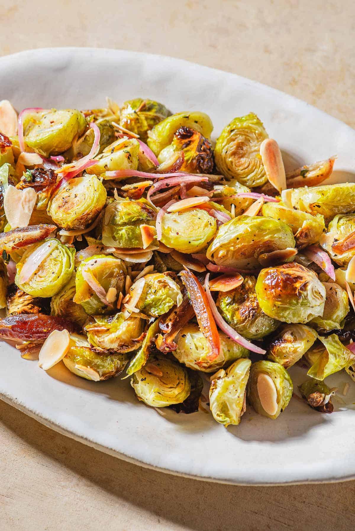 Close-up shot of roasted Brussels sprouts with dates and almonds