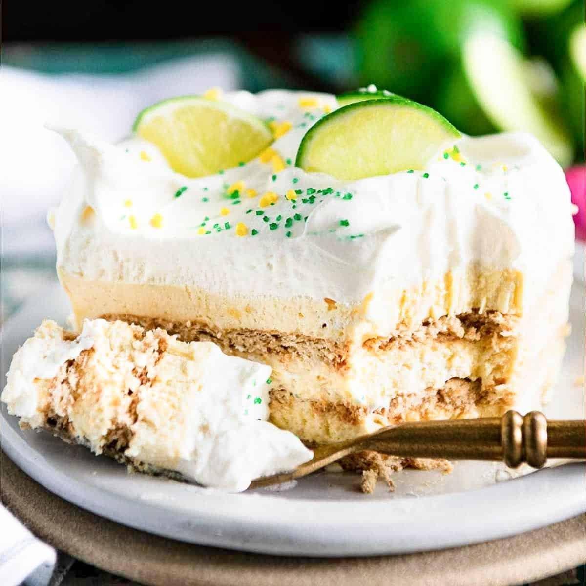 close-up of a slice of key lime cake showing the graham cracker crust and creamy filling